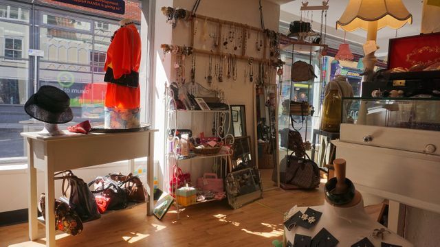 Clothing rails and second-hand finds inside a charity shop