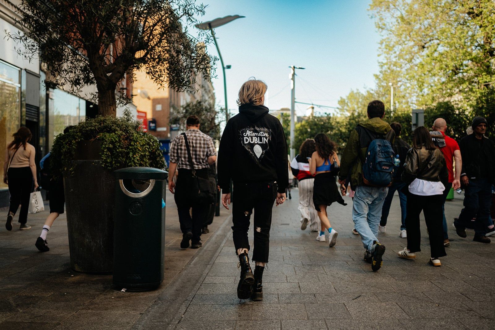 Tour guide leading a group of guests along a busy pedestrian street