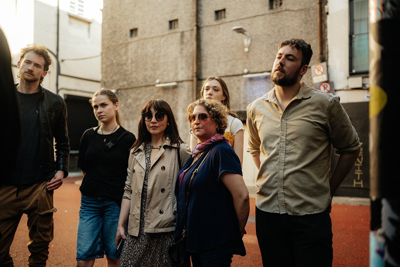 Group of guests looking up at an artwork during a street art tour