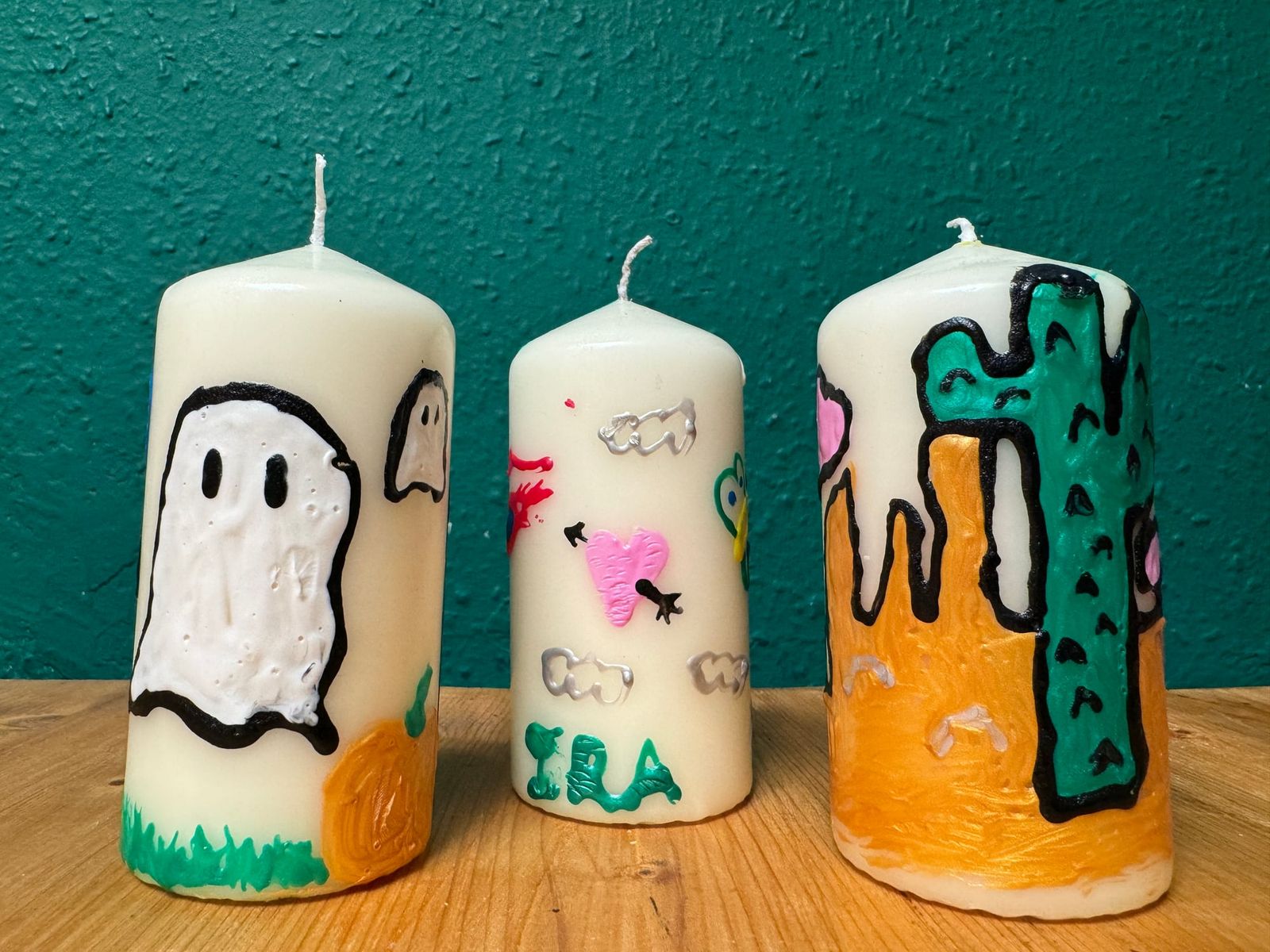 Finished candle showing a painted desert landscape from a workshop