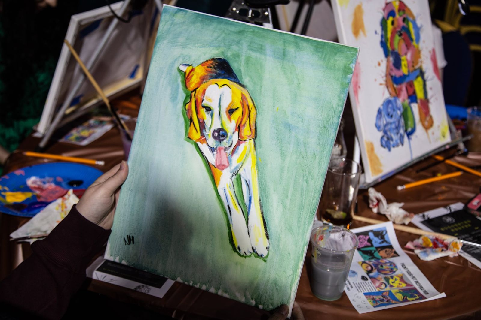 Close-up of a dog portrait painting on a canvas at a paint and sip table